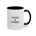 White mug with black handle and text 'EXISTING IS EXPENSIVE' on a white background